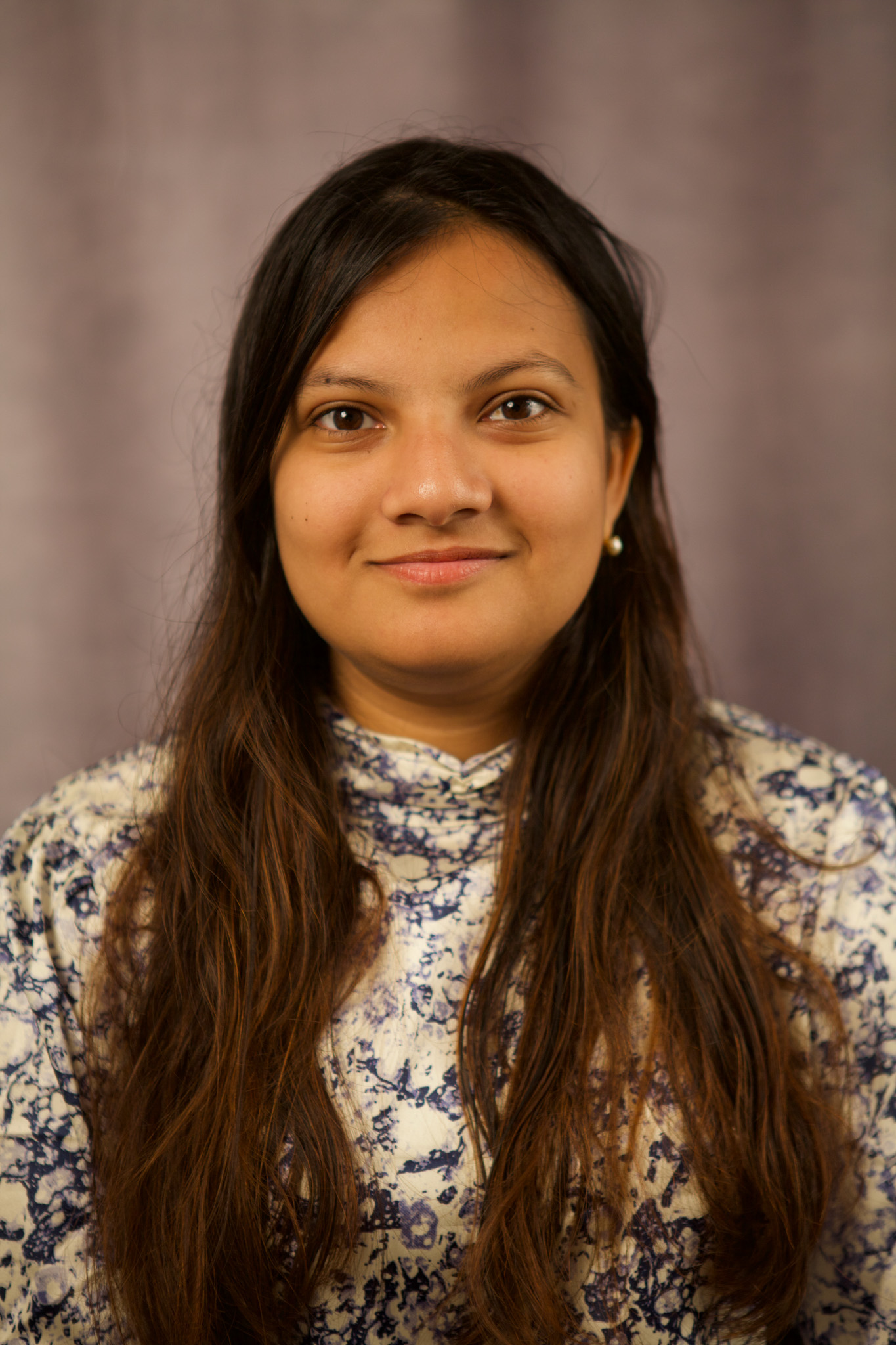 Headshot of Peya Mowar: a woman with brownish black long hair.